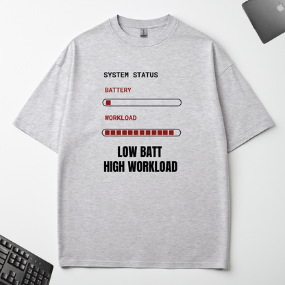 Low Battery High Workload grey oversized t-shirt flat lay on an office desk