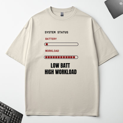 Low Battery High Workload off-white oversized t-shirt flat lay on an office desk