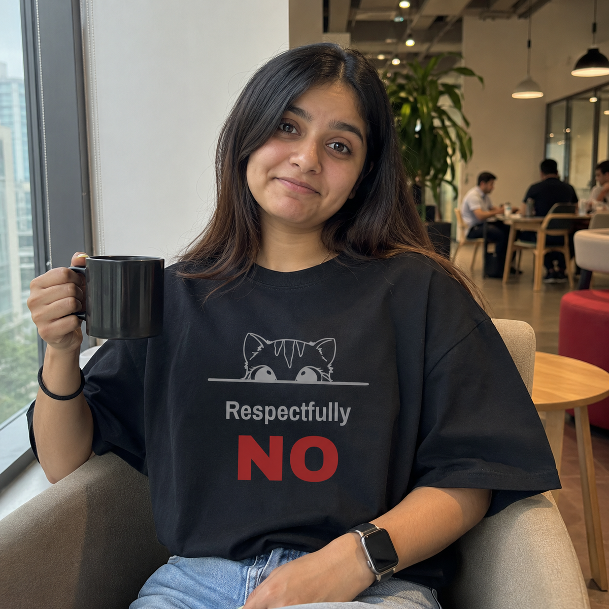 Woman wearing a Respectfully No oversized t-shirt in a modern office